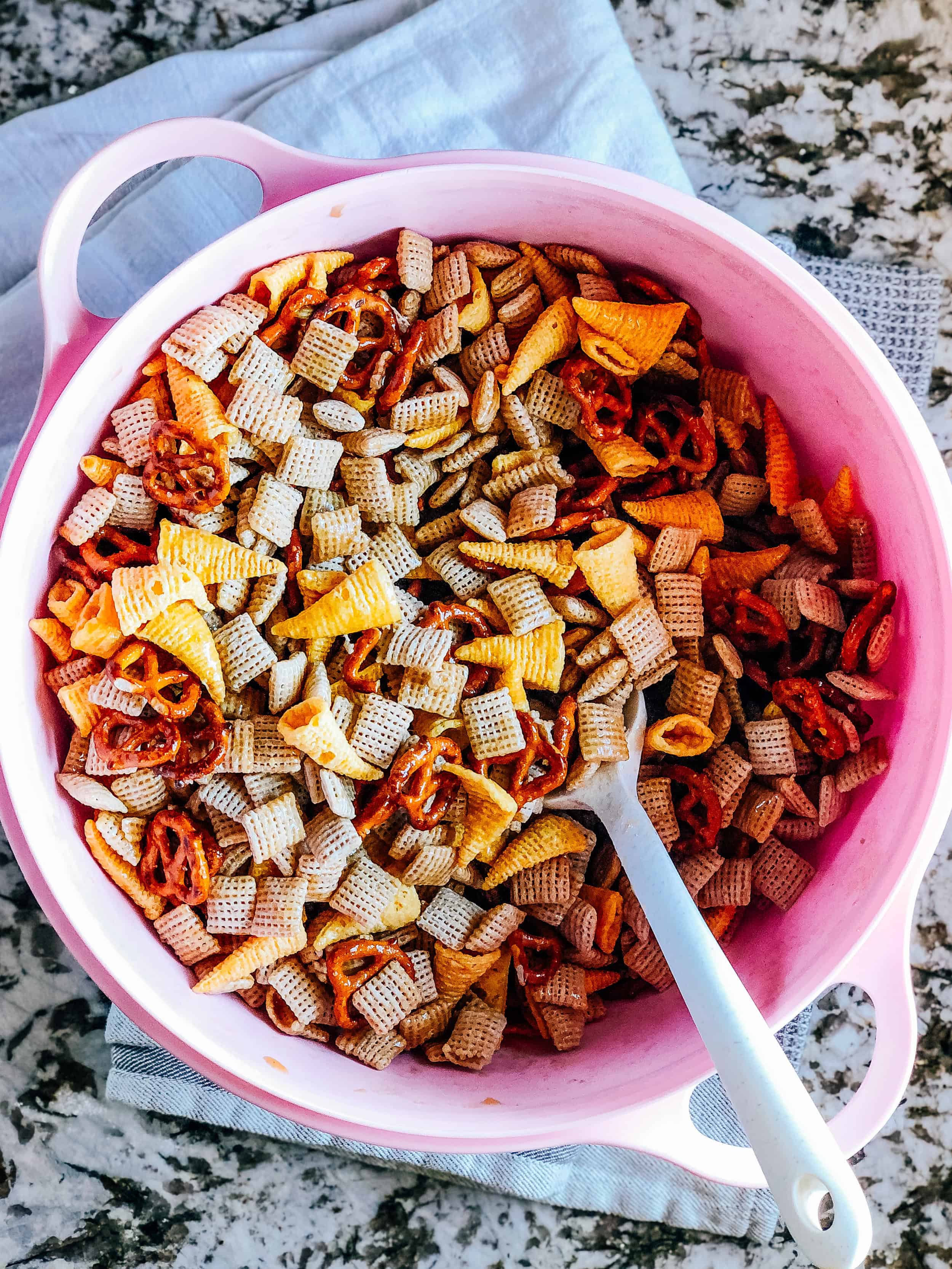 Poured sweet sauce over the cereal and chip mix in the large bowl.