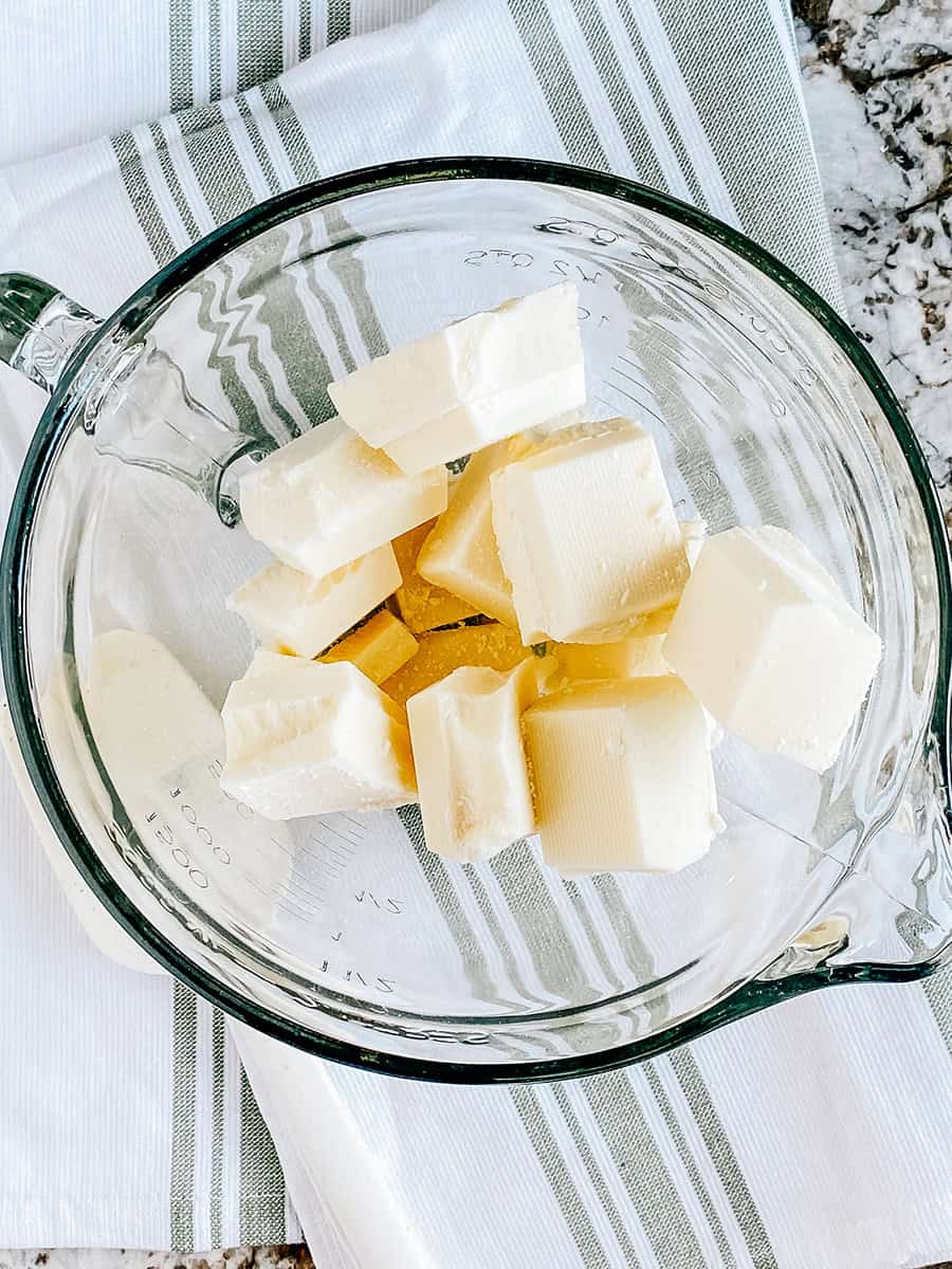 Cubes de chocolat blanc brisés dans un bol en verre allant au micro-ondes.