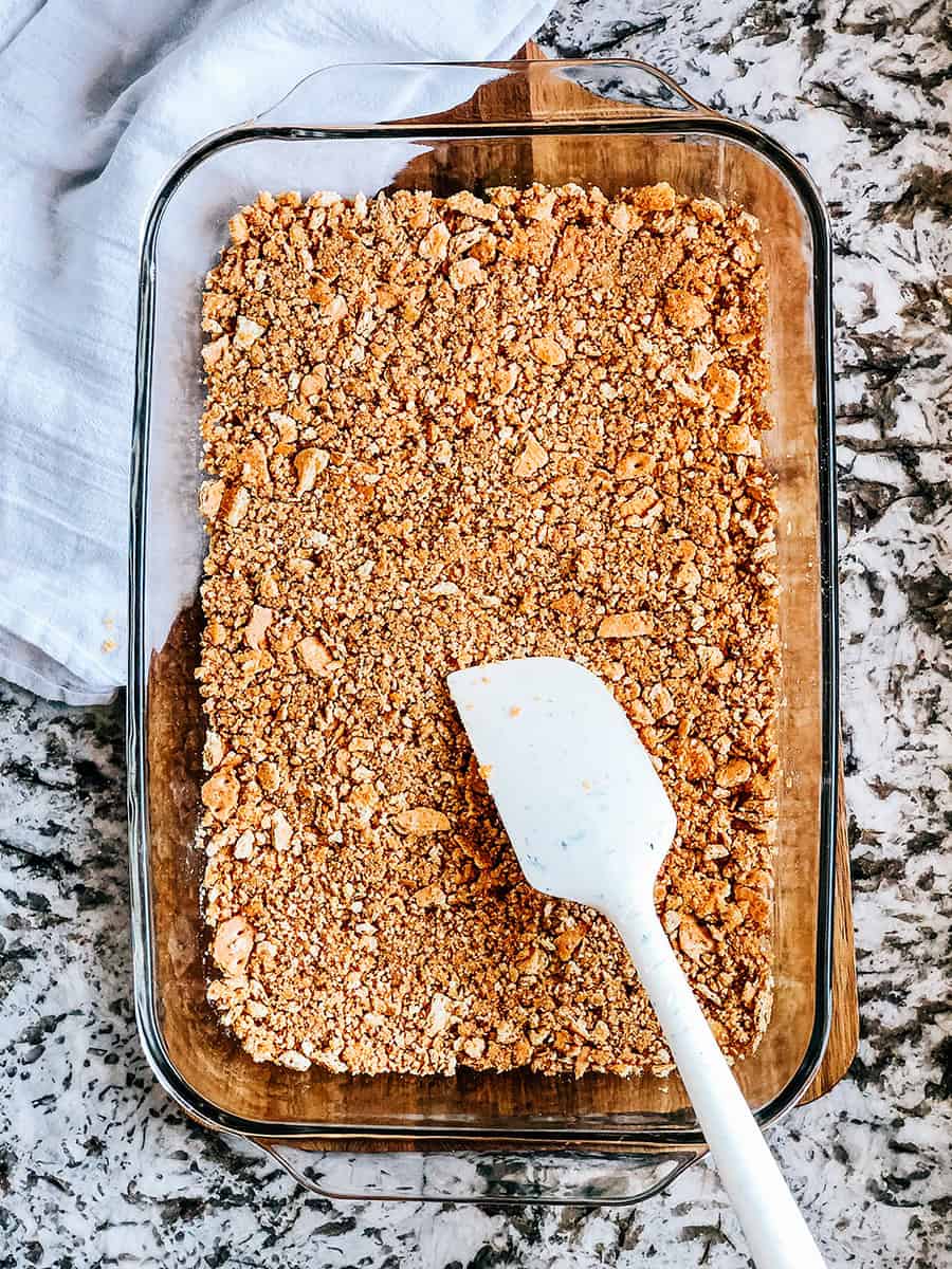 Mélange de beurre fondu et de miettes de biscuits graham pressées dans une simple croûte.