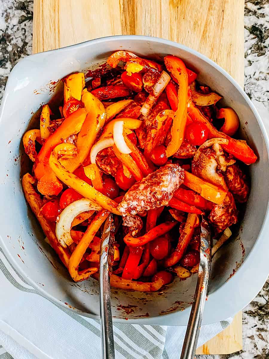 Completely covered cut and sliced sausage and vegetables in a homemade marinade.