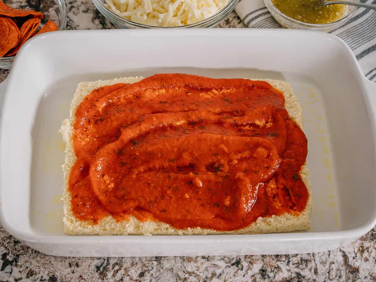 Une pâte couverte de sauce spaghetti dans un plat de cuisson.