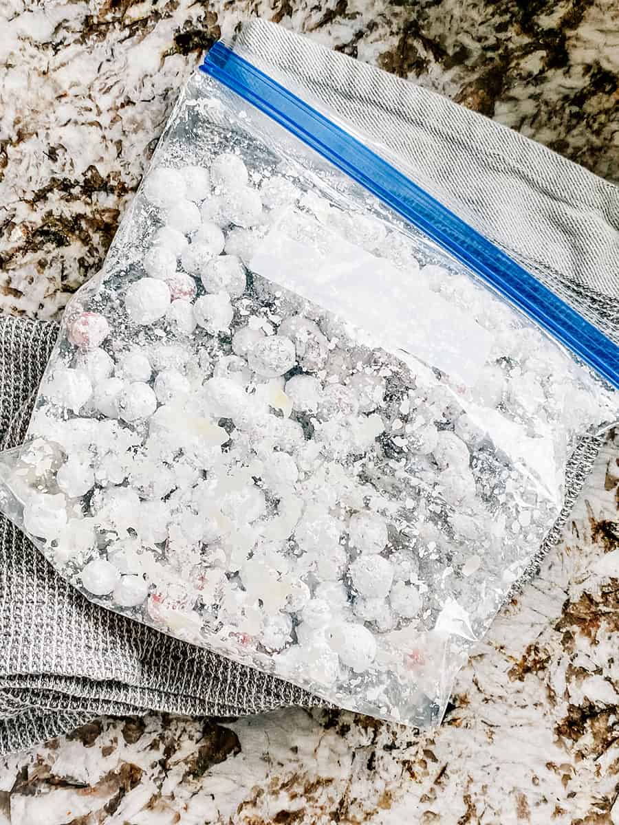 Cranberries coated in powdered sugar in a sealed zip-lock bag.