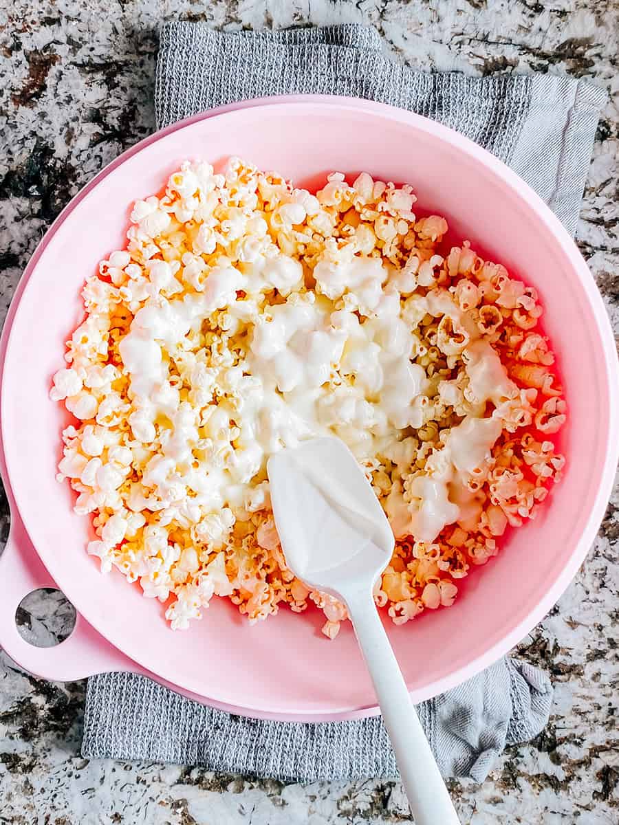 Pop-corn dans un grand bol avec le chocolat d'amande fondu sur le dessus.